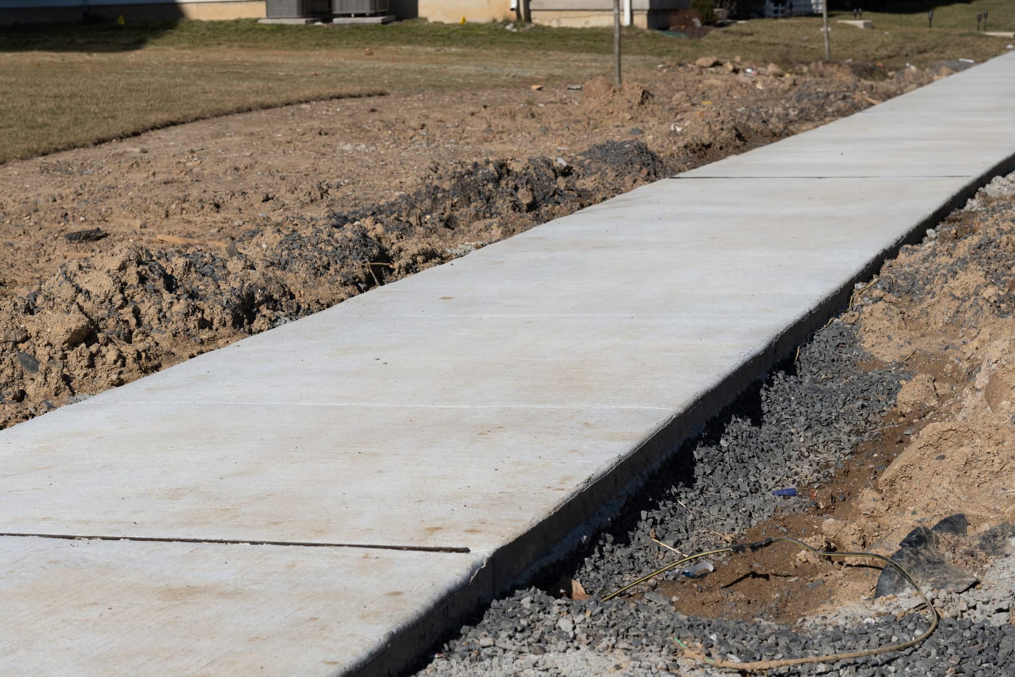 Finished sidewalk with crisp edges set in a graded trench